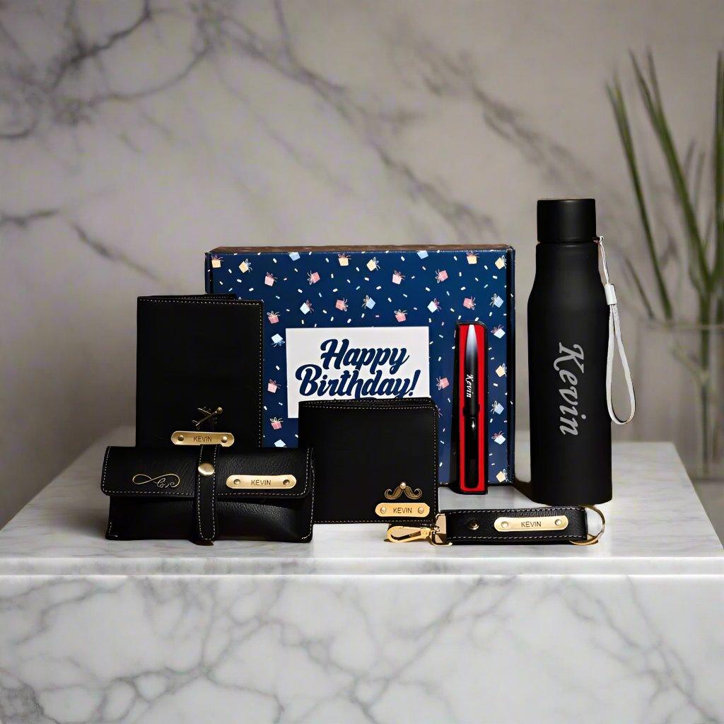 Men’s birthday gift box set with personalized black wallet, bottle, pen, and accessories.