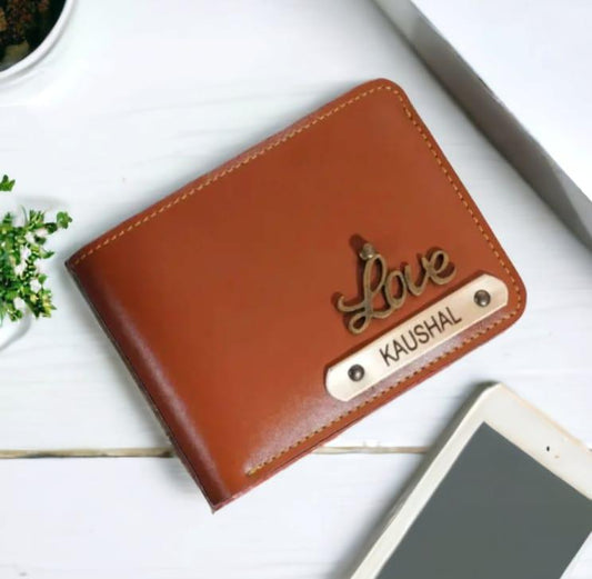 Brown faux leather men's wallet with personalized metal nameplate and 'Love' charm on a white table.