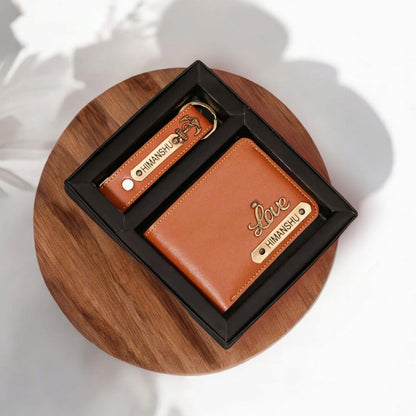 Personalized men's brown leather wallet and keychain gift set in a black box on a wooden surface