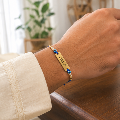 Engraved name rakhi with evil eye beads worn on wrist
