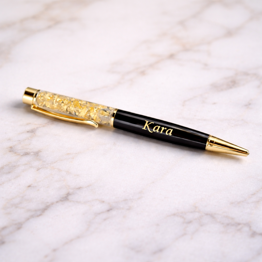 Personalized black and gold pen with name Kara on marble surface, luxury stationery gift