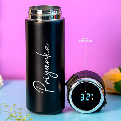Black personalised water bottle with digital temperature display, floral background.