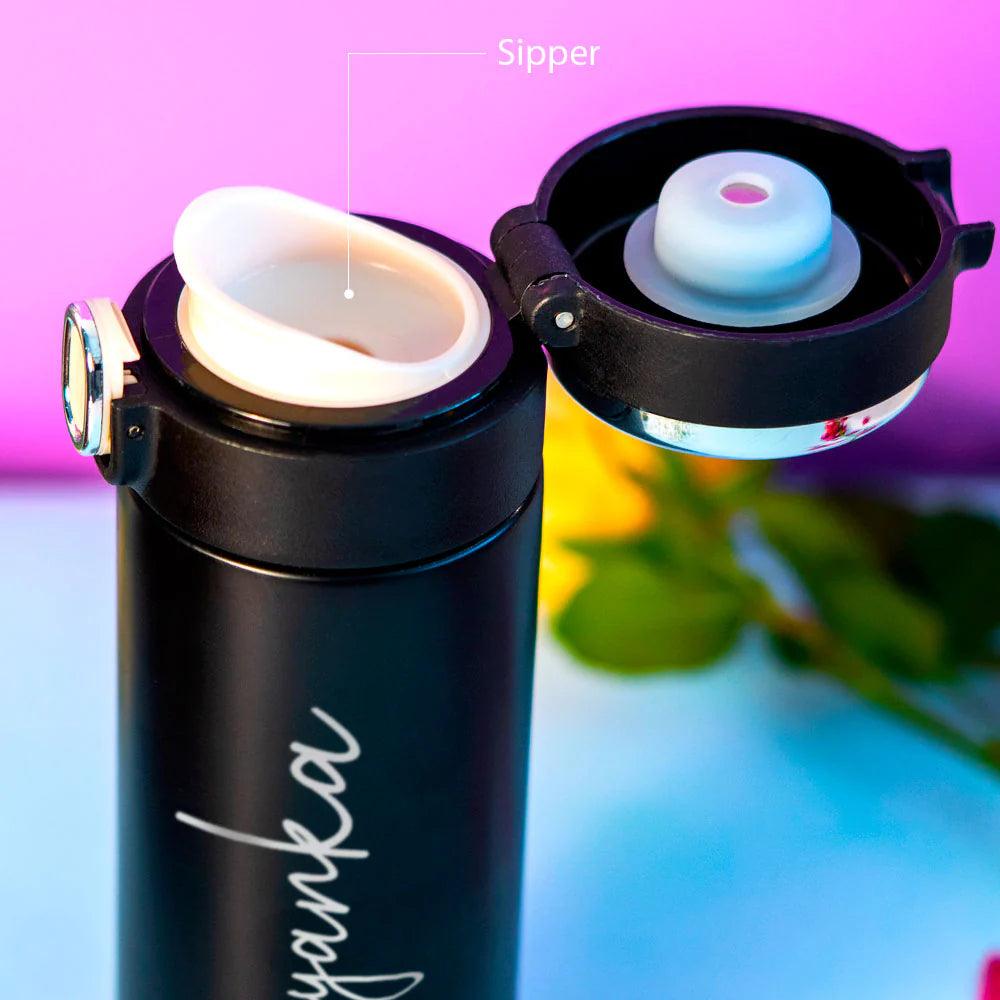 Black personalized water bottle with open lid and sipper, temperature display on side.