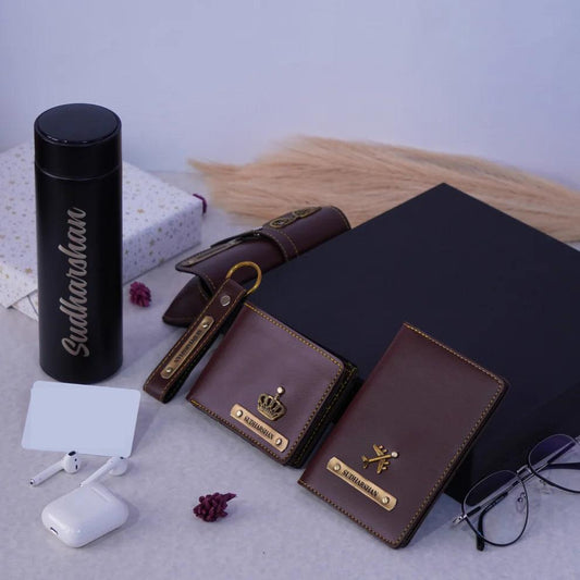 Personalized men's gift set with engraved wallet, passport cover, black flask, and keychain.