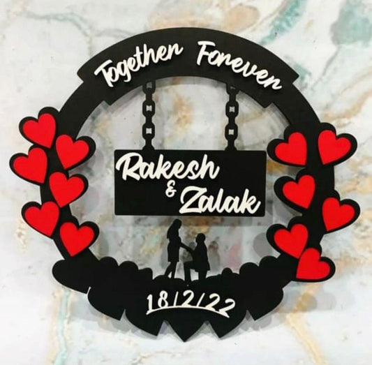 Personalized wooden round wall hanging with red hearts, custom names, and date engraving.