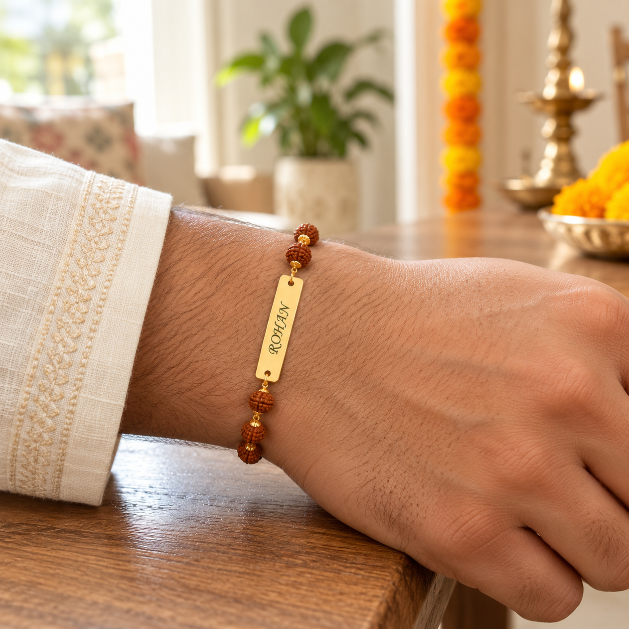 Engraved rudraksha name rakhi with gold plate worn on wrist